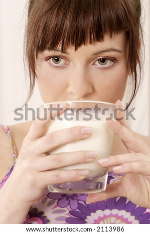 young girl woman with a glass of milk-on white